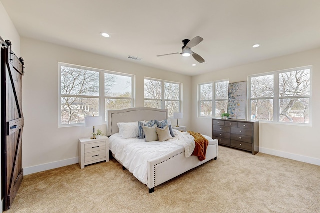 bedroom featuring recessed lighting, a barn door, baseboards, and light colored carpet