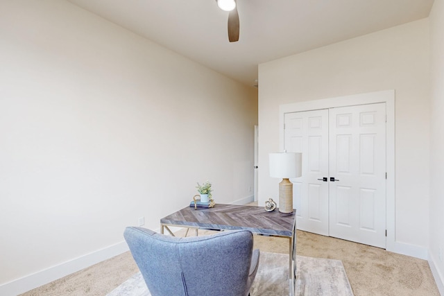 home office with light carpet, baseboards, and ceiling fan