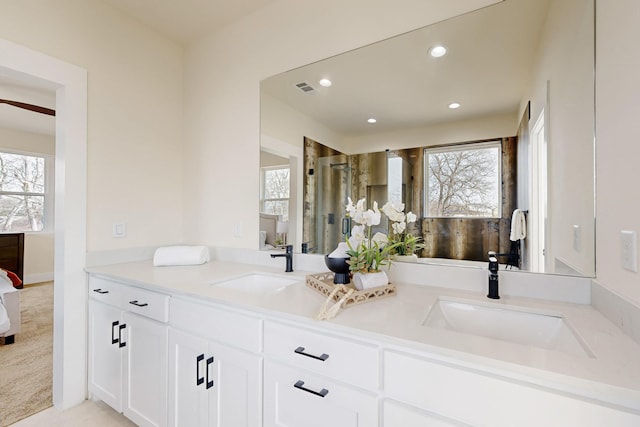 bathroom with plenty of natural light, a sink, and ensuite bath