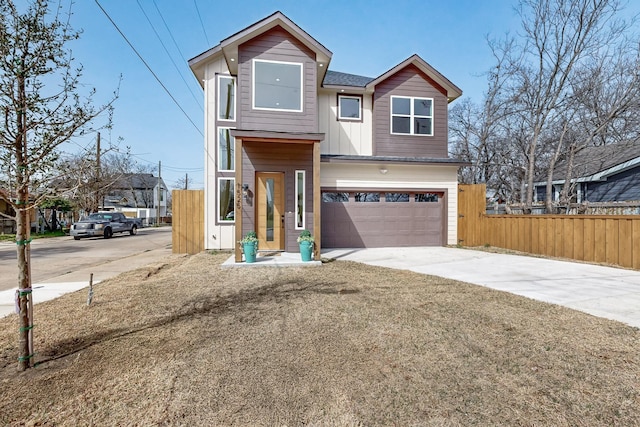 view of front of home with an attached garage, fence, board and batten siding, and concrete driveway