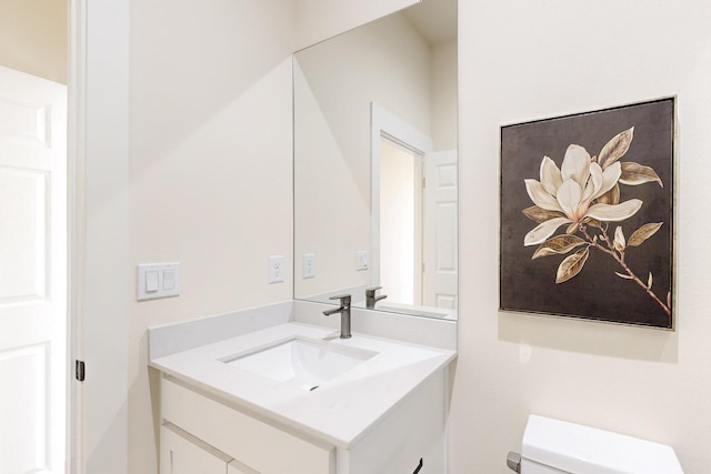 bathroom featuring toilet and vanity