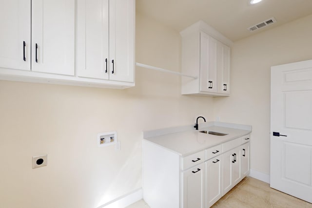 laundry area with visible vents, hookup for a washing machine, a sink, electric dryer hookup, and cabinet space