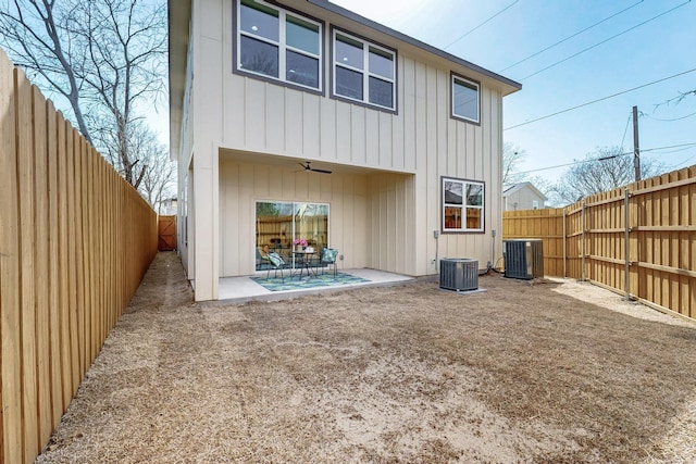 rear view of property with ceiling fan, central AC unit, a patio area, and a fenced backyard