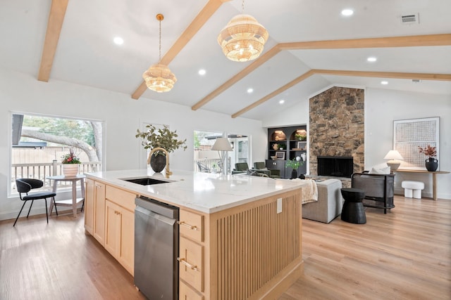 kitchen with vaulted ceiling with beams, light brown cabinets, a sink, visible vents, and stainless steel dishwasher