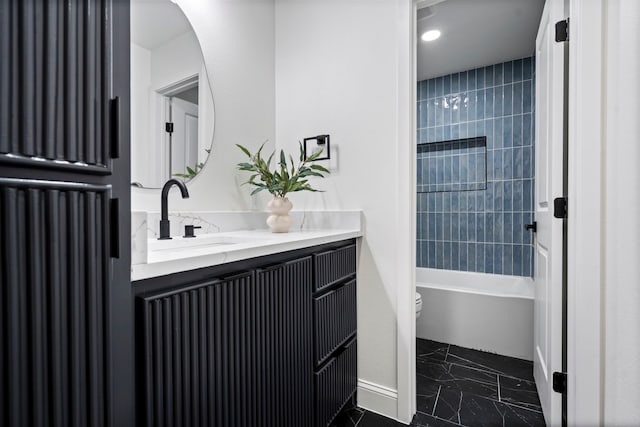 bathroom featuring baseboards, shower / bathing tub combination, vanity, and toilet