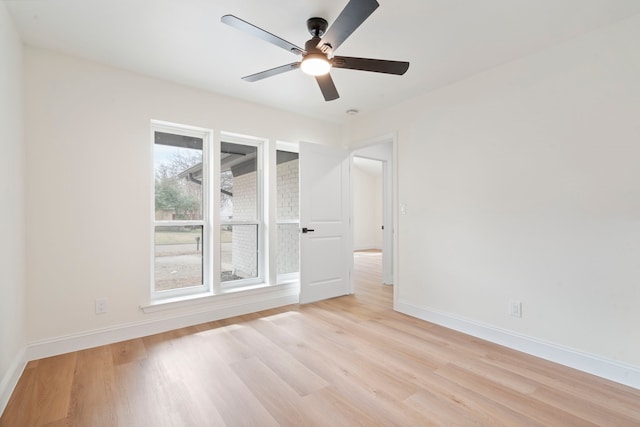 unfurnished room featuring light wood-type flooring, ceiling fan, and baseboards