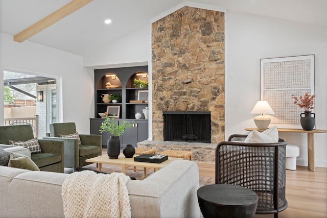 living area featuring built in shelves, a fireplace, wood finished floors, high vaulted ceiling, and beamed ceiling