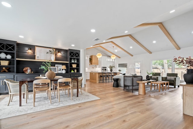 dining room with light wood-style floors, recessed lighting, visible vents, and vaulted ceiling with beams