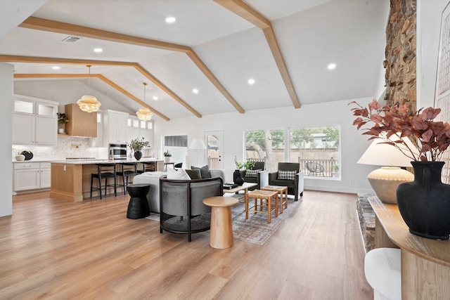 living area with light wood-style floors, baseboards, high vaulted ceiling, and beamed ceiling