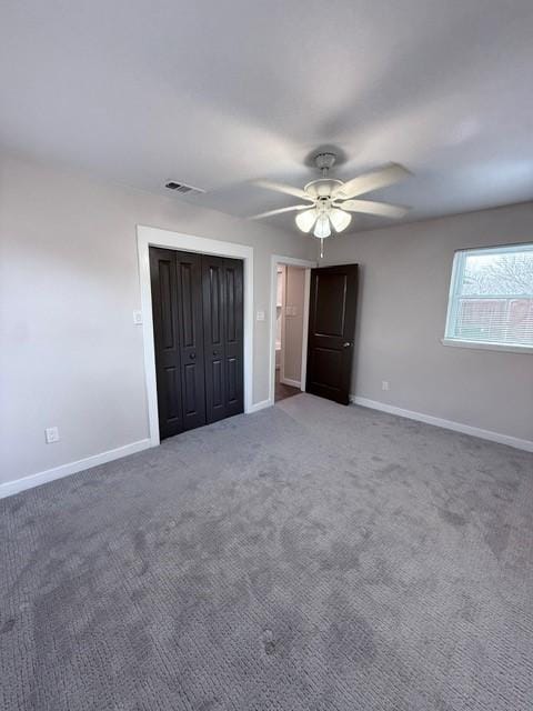 unfurnished bedroom featuring a closet, carpet flooring, a ceiling fan, and baseboards