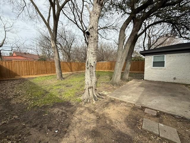 view of yard featuring a patio area and a fenced backyard