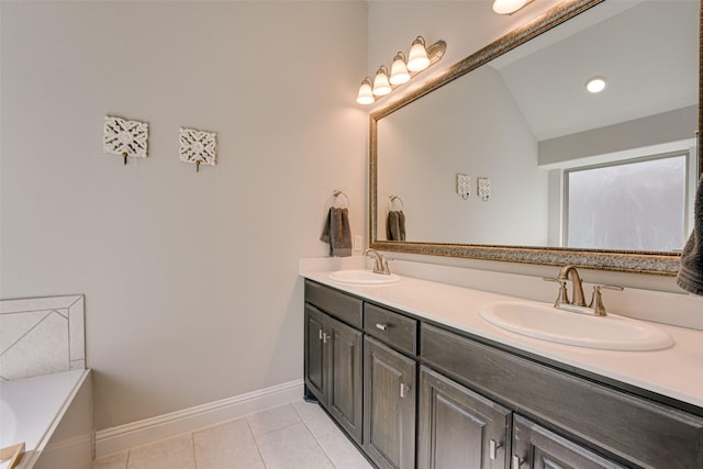 full bath with tile patterned flooring, a sink, baseboards, and double vanity