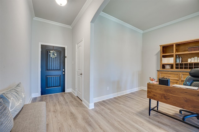 entrance foyer featuring light wood finished floors, baseboards, and arched walkways