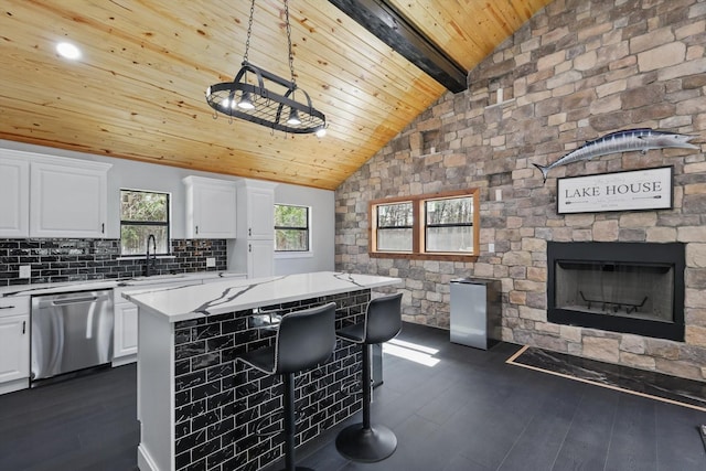 kitchen with light countertops, dishwasher, wooden ceiling, dark wood-style flooring, and white cabinetry