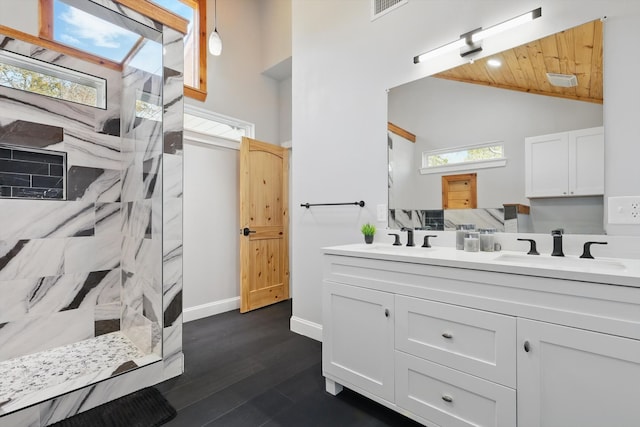 bathroom with wood ceiling, lofted ceiling, a sink, and a walk in shower