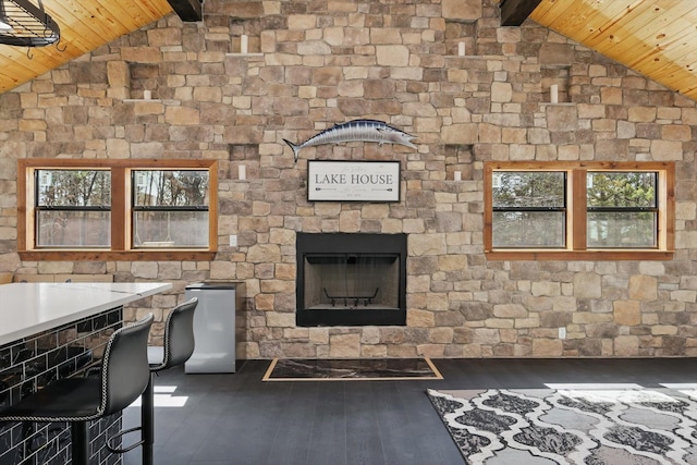 living room featuring wood-type flooring, a fireplace, wood ceiling, and lofted ceiling with beams
