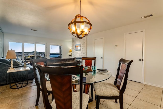 dining room featuring visible vents, a notable chandelier, baseboards, and light tile patterned flooring