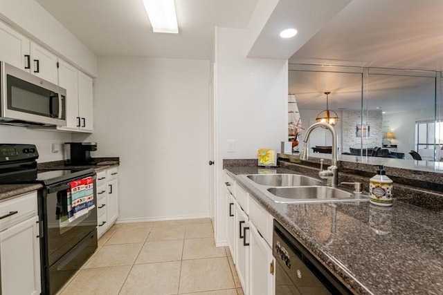 kitchen featuring light tile patterned floors, a sink, white cabinetry, black appliances, and dark stone countertops