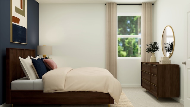 bedroom with baseboards and light colored carpet