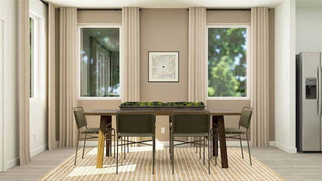 dining room featuring breakfast area, wood finished floors, and baseboards