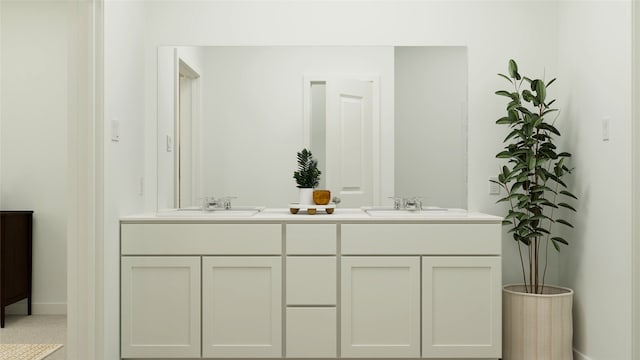 bathroom with double vanity, baseboards, and a sink