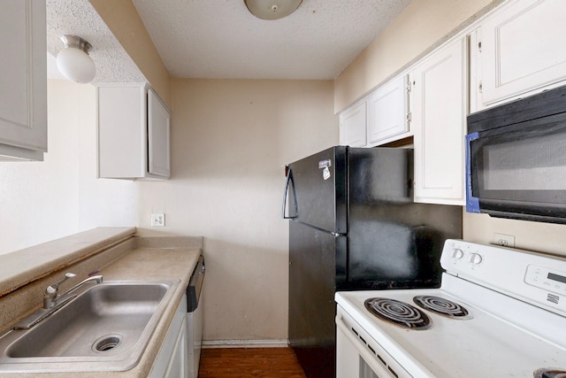 kitchen featuring white electric stove, a sink, black microwave, a textured ceiling, and white cabinetry