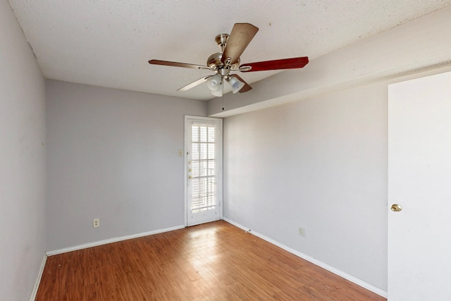 unfurnished room with light wood finished floors, ceiling fan, and baseboards