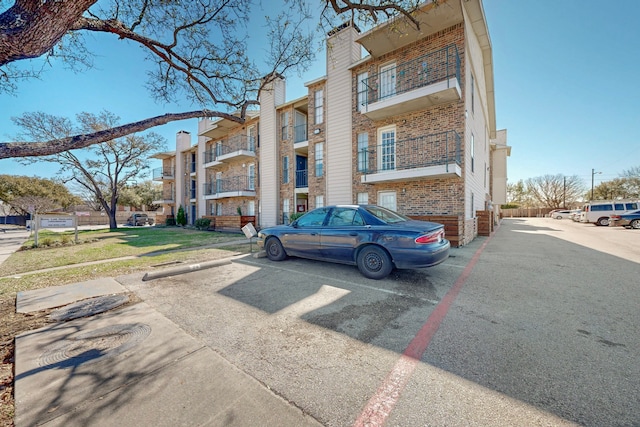 view of property featuring uncovered parking