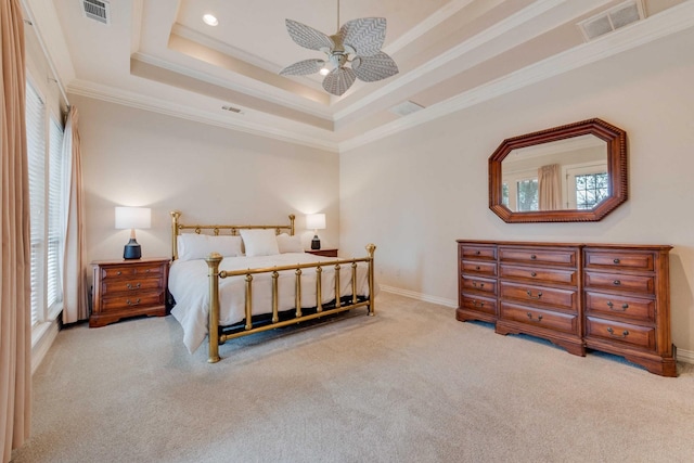 carpeted bedroom featuring ornamental molding, a raised ceiling, visible vents, and recessed lighting