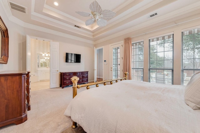 bedroom featuring ornamental molding, a raised ceiling, visible vents, and light colored carpet