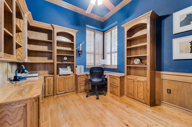 office featuring built in desk, light wood-style floors, ornamental molding, and a ceiling fan