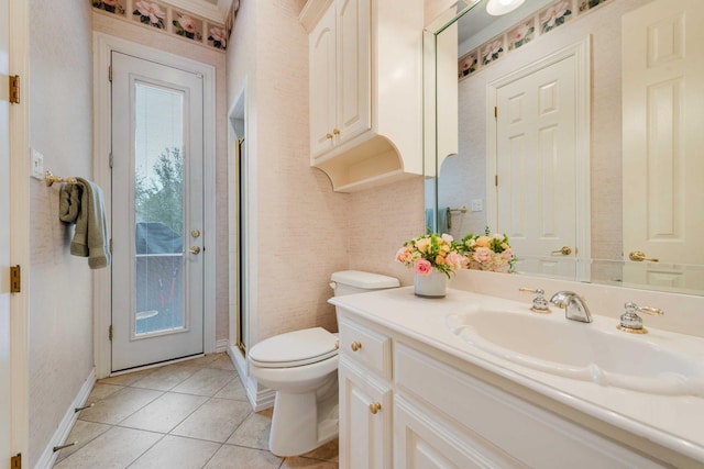 full bath featuring a stall shower, baseboards, toilet, tile patterned flooring, and vanity