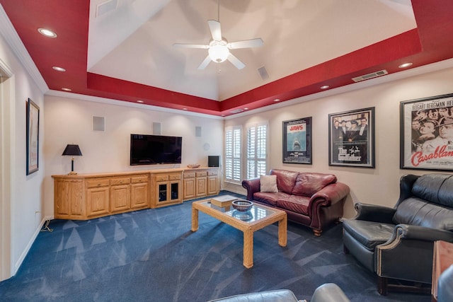 living area featuring a tray ceiling, baseboards, visible vents, and dark colored carpet