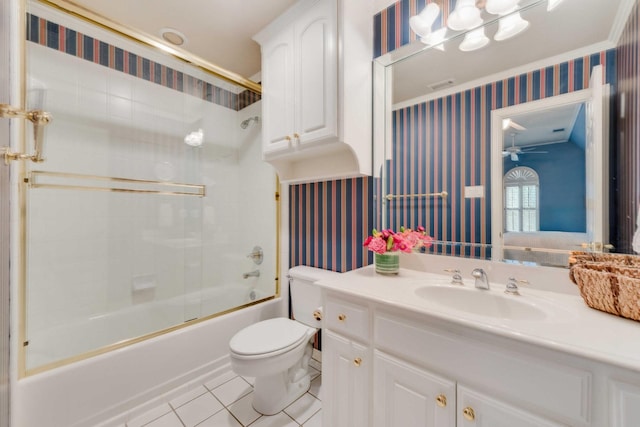 bathroom with toilet, bath / shower combo with glass door, vanity, tile patterned floors, and wallpapered walls