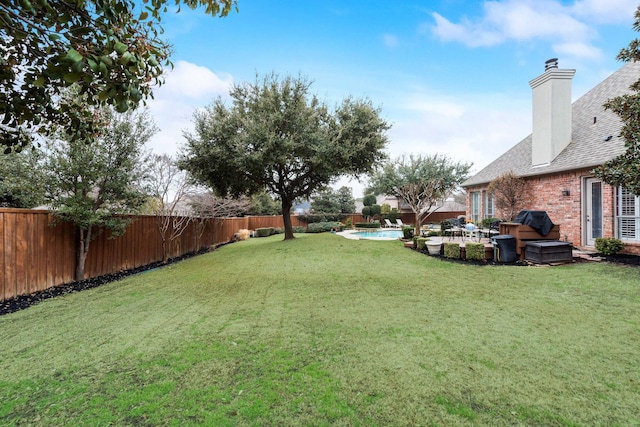 view of yard featuring a fenced backyard, a fenced in pool, and a patio