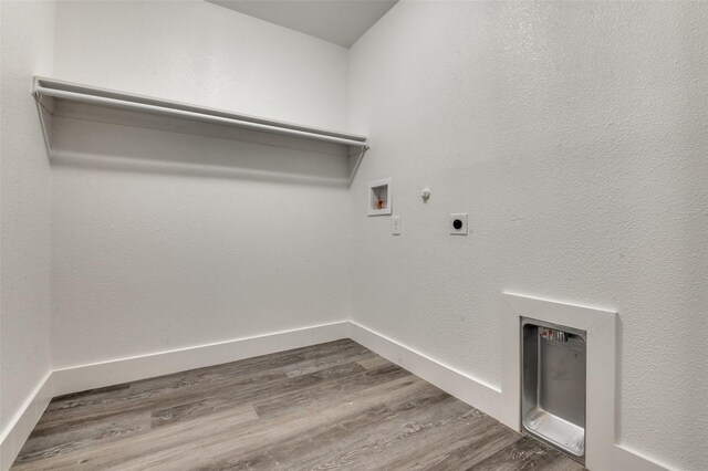 laundry area featuring dark wood finished floors, hookup for a washing machine, hookup for an electric dryer, gas dryer hookup, and laundry area