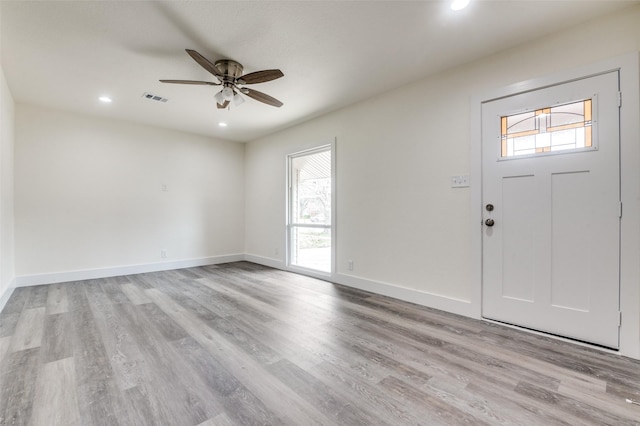 foyer with light wood finished floors, visible vents, and a healthy amount of sunlight