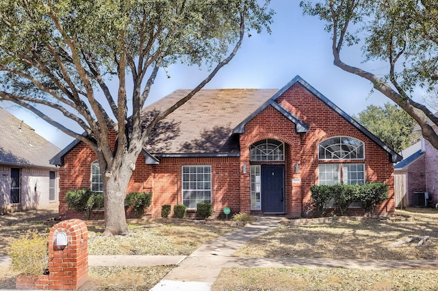 view of front of property with cooling unit and brick siding