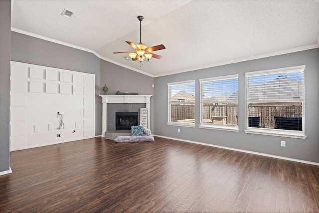 unfurnished living room featuring vaulted ceiling, a brick fireplace, wood finished floors, and crown molding