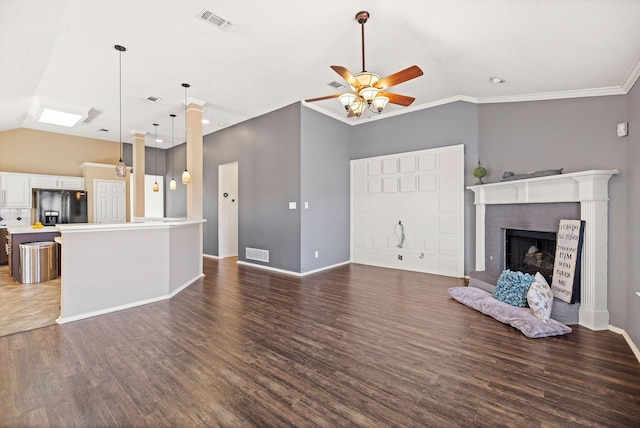 unfurnished living room with dark wood-style floors, vaulted ceiling, a fireplace, and visible vents