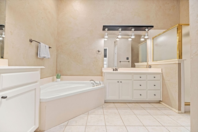 full bathroom featuring vanity, tile patterned flooring, and a bath