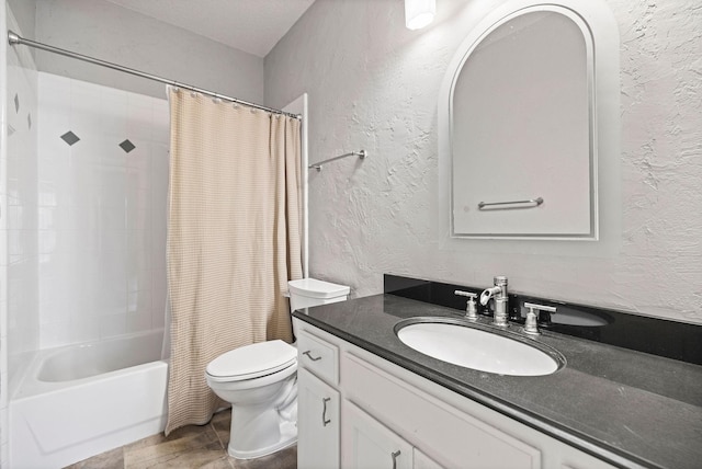 full bath with a textured wall, shower / tub combo, vanity, and toilet