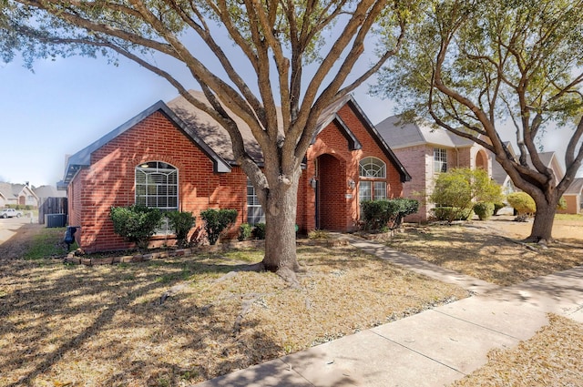 view of front of home with brick siding and cooling unit