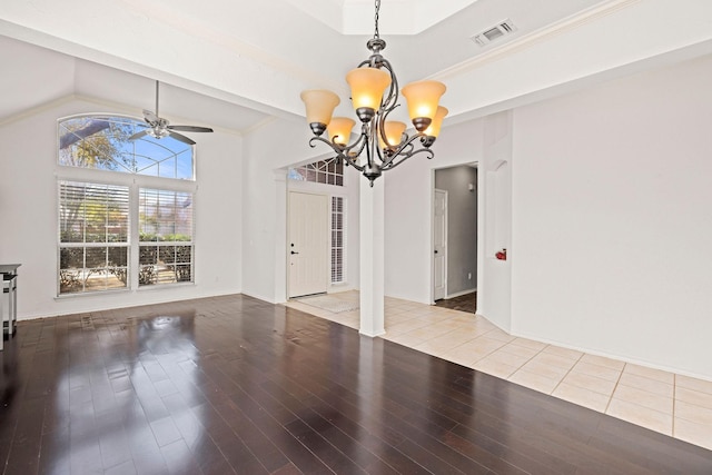 unfurnished dining area with lofted ceiling, visible vents, wood finished floors, and ceiling fan with notable chandelier