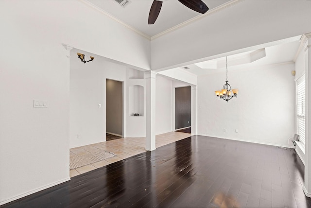 unfurnished room featuring crown molding, a tray ceiling, wood finished floors, and ceiling fan with notable chandelier