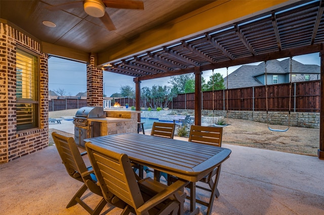 view of patio / terrace with an outdoor kitchen, area for grilling, a fenced backyard, a pergola, and outdoor dining space