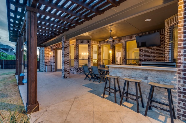 view of patio with outdoor dry bar, fence, and a pergola