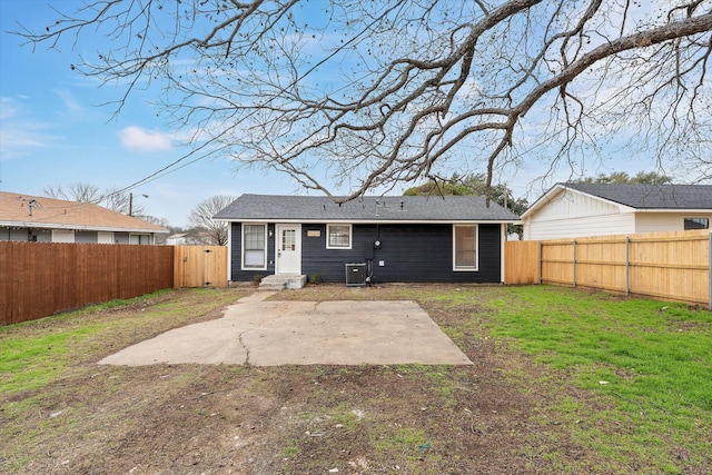 back of property with a patio area, a fenced backyard, central AC, and a lawn