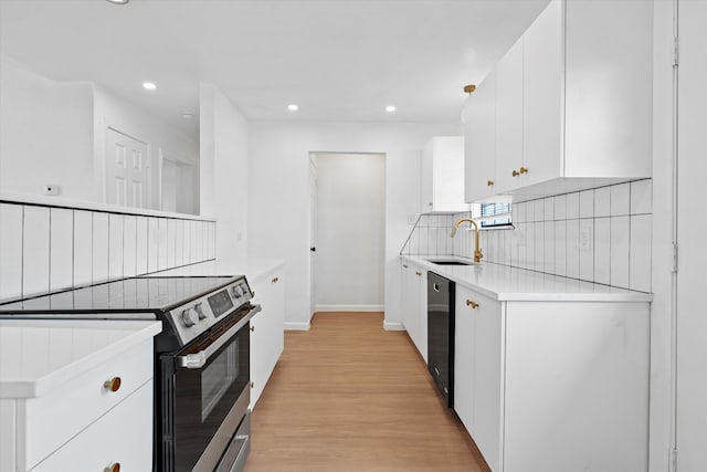 kitchen with a sink, white cabinetry, light wood finished floors, stainless steel range with electric stovetop, and tasteful backsplash