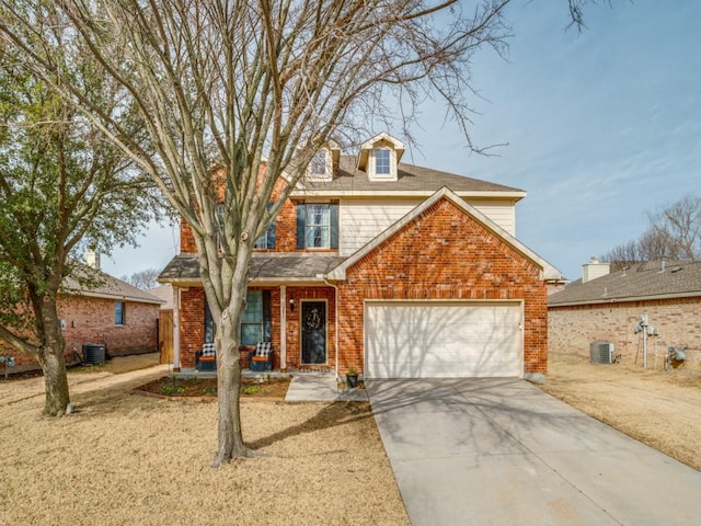 view of front of home with driveway, brick siding, an attached garage, and central air condition unit